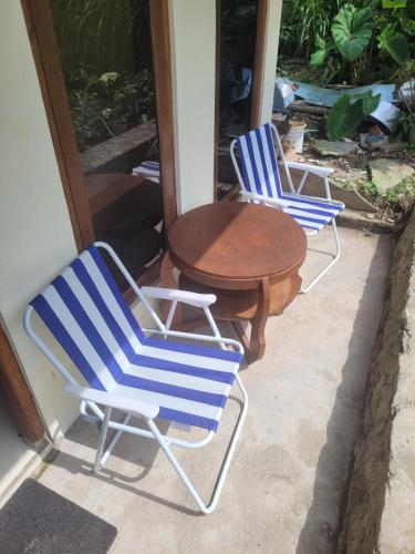 two blue and white chairs and a table on a porch at Ayem Tentrem Homestay in Selo