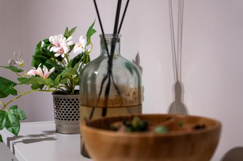 a glass vase sitting on top of a table with a bowl at A due passi dal Mare - Il Faro sul Mare in Sori