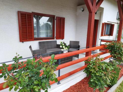 a porch with chairs and a table and some plants at Kuća za odmor Ria in Gornja Voća
