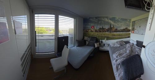 a room with a living room with a couch and a table at Helles WG Zimmer 1von4 in fantastischer Attikawohnung in Oetwil am See