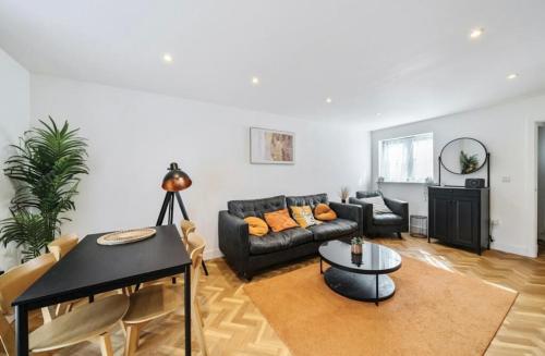 a living room with a couch and a table at 1 The orchard - Beautiful Ground floor garden flat in Frampton Cotterell