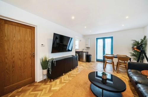 a living room with a couch and a table at 1 The orchard - Beautiful Ground floor garden flat in Frampton Cotterell