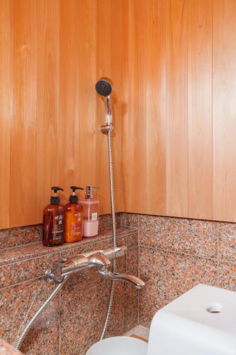 a bathroom counter with a sink and a toilet at ホタル屋 in Takashima