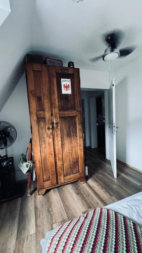 a room with a wooden cabinet in a bedroom at Domus Merian XII in Trier