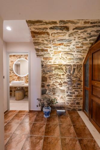 a room with a stone wall and a doorway at Casita in Ermoupoli