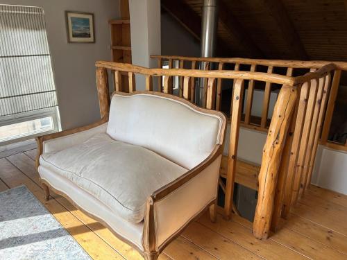 a wooden chair sitting in a room at Your Home in Mevasseret Zion in Mashabbe Sade