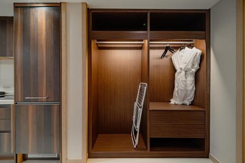 a closet with a robe hanging on a rack at Masion Sanbang Jeju in Seogwipo