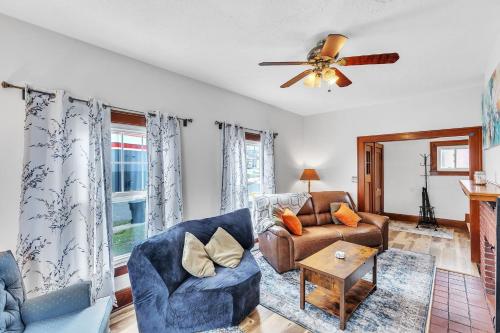 a living room with a couch and a ceiling fan at Cozy Getaway with Hot Tub, Patio & Fenced Yard home in Garfield Heights