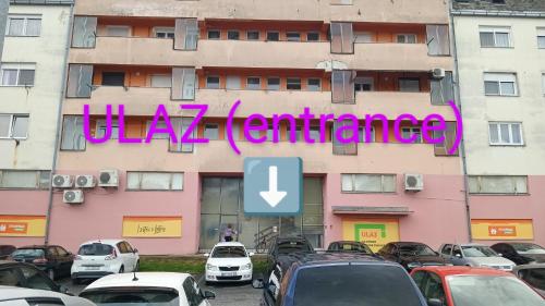 a building with a sign that reads jaza gratification at Studio apartman Barbara in Virovitica