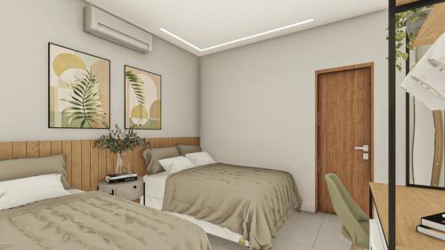 a bedroom with two beds and a desk with a tv at Pousada Miray Olímpia in Olímpia