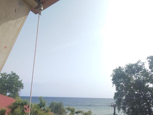 a view of the ocean from a house at Eleni Kandilari Rooms in Kókkinon Nerón