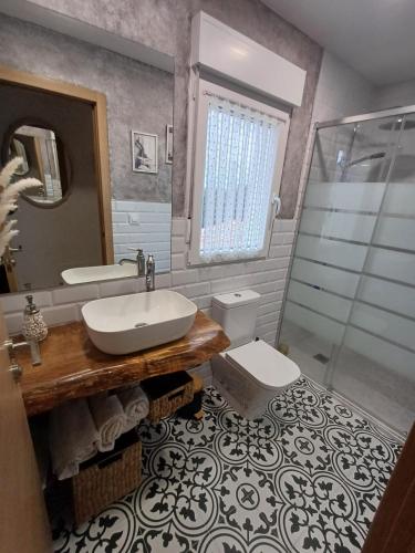 a bathroom with a sink and a toilet and a shower at "La casuca de Finu" #1# Santillana del Mar in Arroyo
