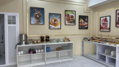 a room with shelves filled with different types of items at Chinor Hotel Fergana in Fergana