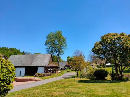 a home with a driveway leading to a house at Apartmány Slavíkov - Country Suite in Horní Radechová