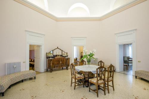a dining room with a table and chairs at Villa La Meridiana - Caroli Hotels in Leuca