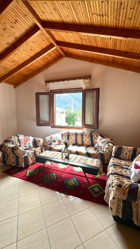 a living room with two couches and a window at Magnus Apartments in Dukat