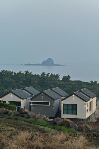 a row of houses with solar panels on them at Masion Sanbang Jeju in Seogwipo