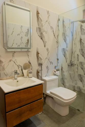 a bathroom with a toilet and a sink and a mirror at Celine Resorts Kumrat Valley in Tāl