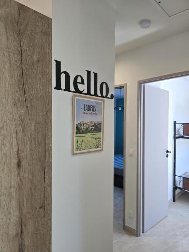 a sign on a wall in a room with a door at Cocoon Luberon in Lauris