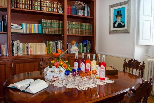 a table with wine bottles and glasses on it at Villa La Meridiana - Caroli Hotels in Leuca