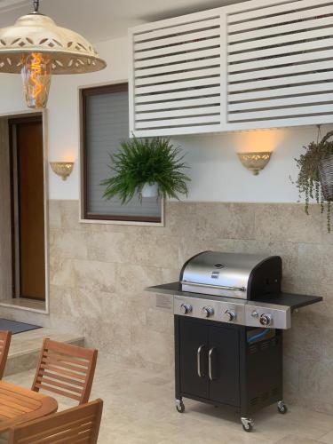 a kitchen with a grill and a table with chairs at Moon Luxury in Lecce