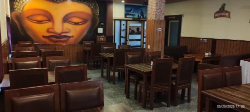 a restaurant with wooden tables and a large head on the wall at HOTEL SUN STAR INTERNATIONAL Pvt Ltd in Bhairāhawā