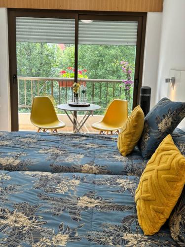 a bedroom with a bed and a table and chairs at El Malecon in Sarria