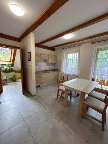 a kitchen with a table and chairs in a room at Pokoje Gościnne Młyn Bosaka in Ojców