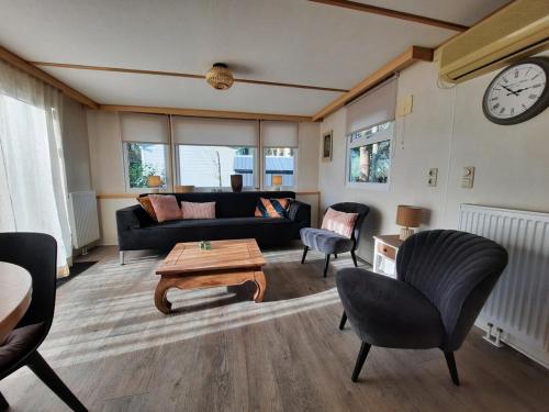 a living room with a couch and a table at Groene Oase in Epe