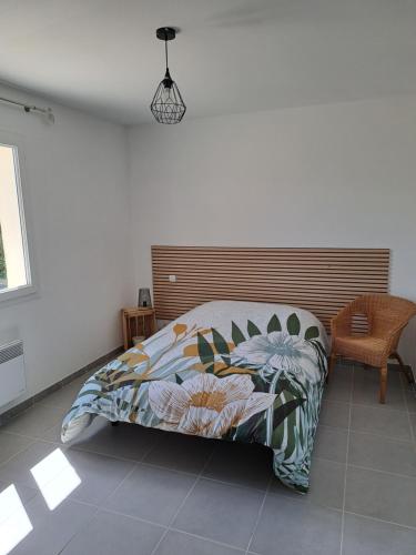 a bedroom with a bed with a colorful comforter at L'art dés choix in Saint-Alexandre