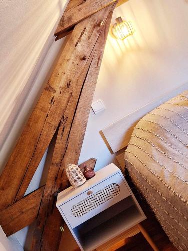 a bedroom with a large wooden wall next to a bed at Gite du hérisson in Saulieu