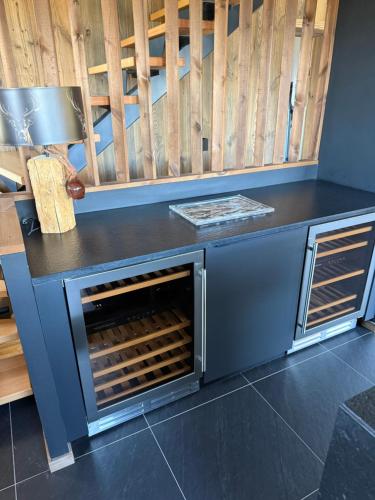 a counter with an open oven in a room at Chalet du rocher Font Romeu in Font Romeu Odeillo Via