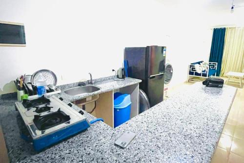 a kitchen with a stove and a counter top at Beach and pools front challet in Ras Sudr families Only عائلات فقط in Ras Sedr
