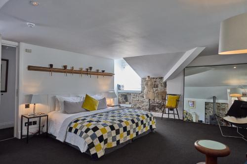 a bedroom with a bed with a checkered blanket at Monachyle Mhor Hotel in Lochearnhead