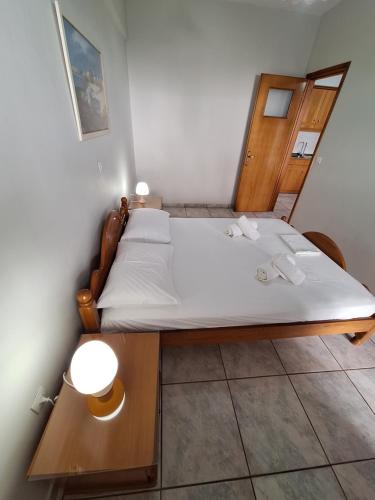 a small bedroom with a bed with a wooden frame at 85 sqm Apartments New Panorama ELECTRIC CAR ΦΩΡΤΗΣΗΣ STATION in Paralion astros
