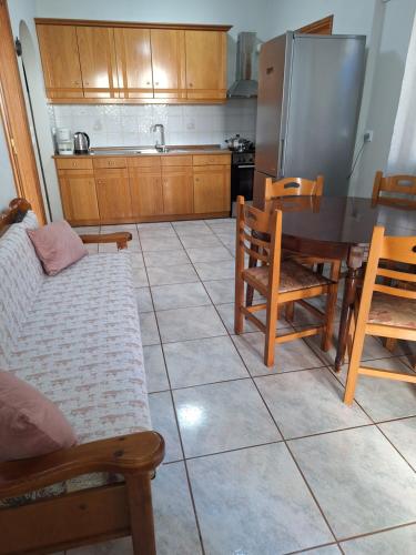 a kitchen with a table and chairs and a refrigerator at 85 sqm Apartments New Panorama ELECTRIC CAR ΦΩΡΤΗΣΗΣ STATION in Paralion astros