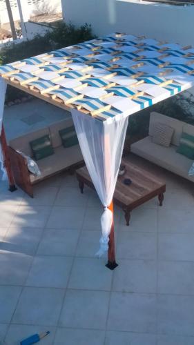 a table with a canopy on a patio at Dar Shayran in El Haouaria