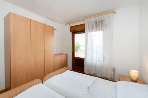 a bedroom with two beds and a window at Spacious Apartments by the Sea in Srima, Vodice in Srima
