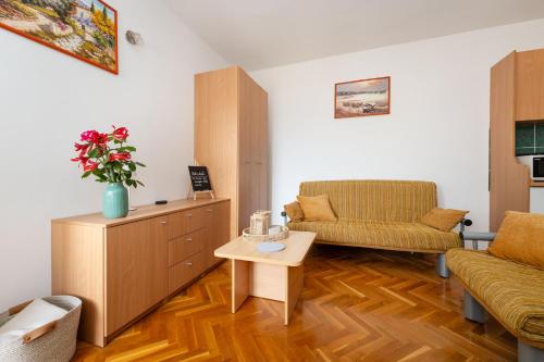 a living room with a couch and a table at Spacious Apartments by the Sea in Srima, Vodice in Srima