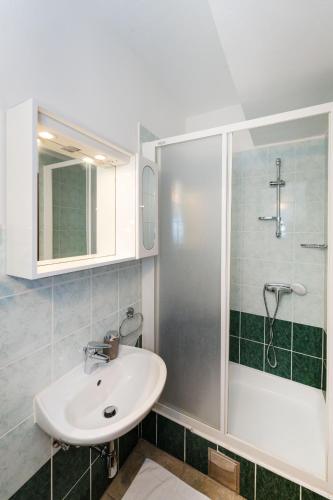 a bathroom with a sink and a shower at Spacious Apartments by the Sea in Srima, Vodice in Srima