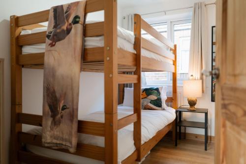 a bedroom with two bunk beds in a room at The Bird's Nest by Sheppey Stays in Sheerness