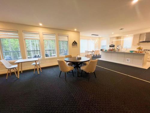 a room with a table and chairs and a kitchen at Morning Dew105 in Hammonds Plains