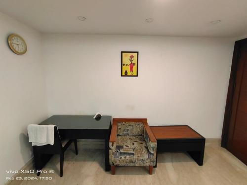 a room with a piano and a bench and a clock at Stay Inn Residency in New Delhi