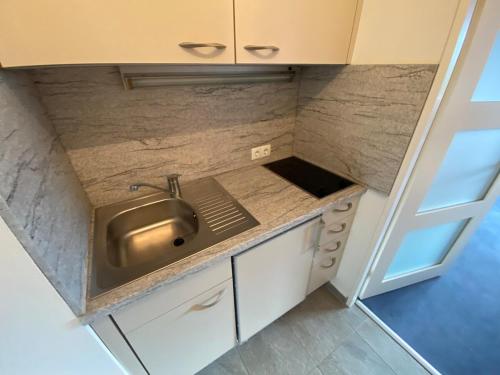 a kitchen with a sink and a counter top at Panoramalounge 712 in Lahnstein