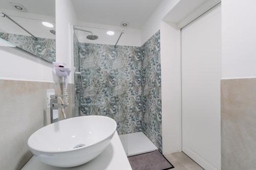 a bathroom with a white toilet and a sink at Franciacorta Rooms 1 in Corte Franca