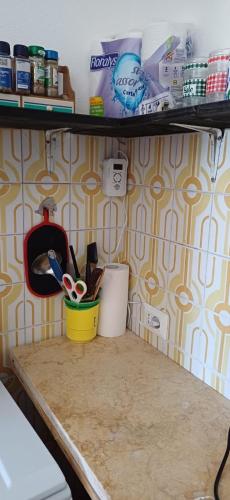 a table with scissors and other items on a wall at Vista mare in Calasetta