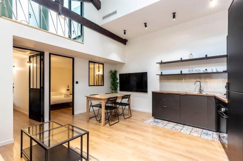 a kitchen and dining room with a table and a sink at Loft Spacieux pour 10 personnes avec Terrasse in Nice