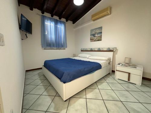a bedroom with a bed and a television in it at AMATI HOLIDAYS in Palermo