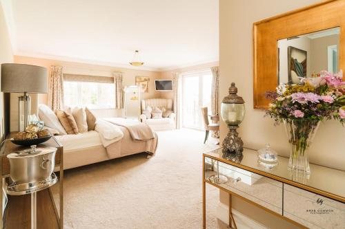 a living room with a couch and a table with flowers at Dodford Grange in Daventry