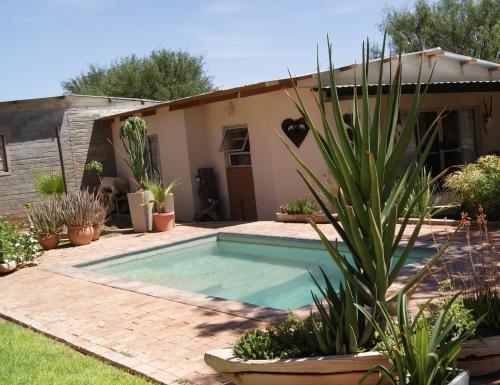 a swimming pool in the backyard of a house at Orpheus Inn Camping in Kaneb Pos